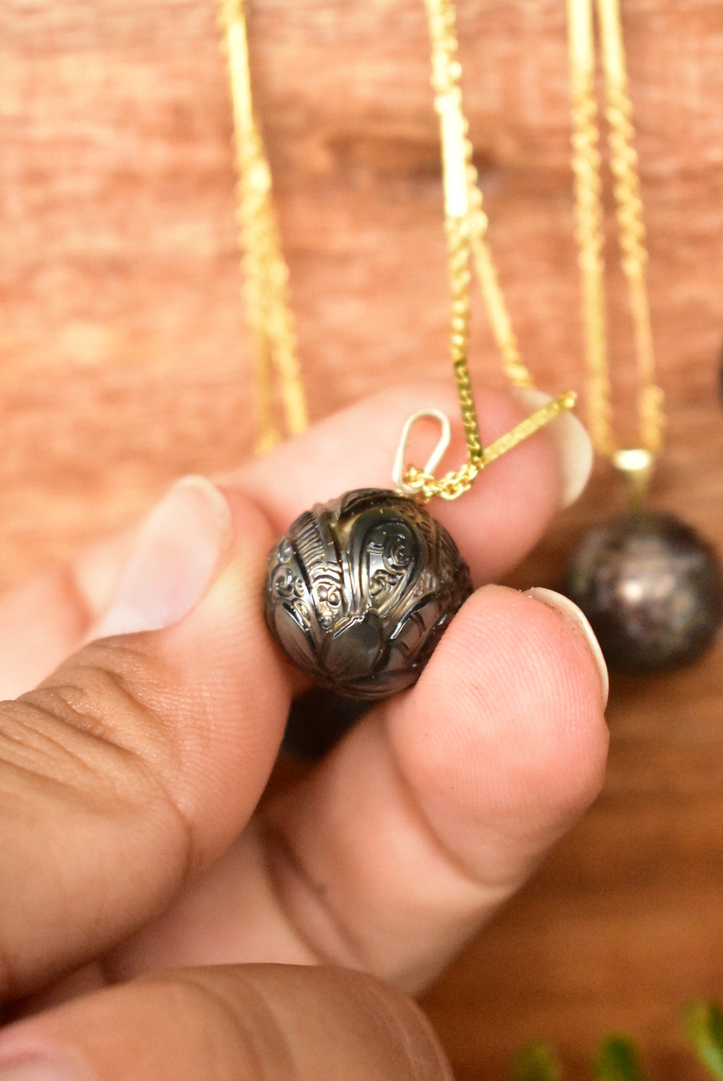 Carved Tahitian pearl pendant